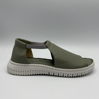 Green sandal with a white sole on a gray background