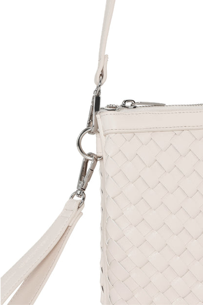 White woven handbag with a clip on strap on a white background