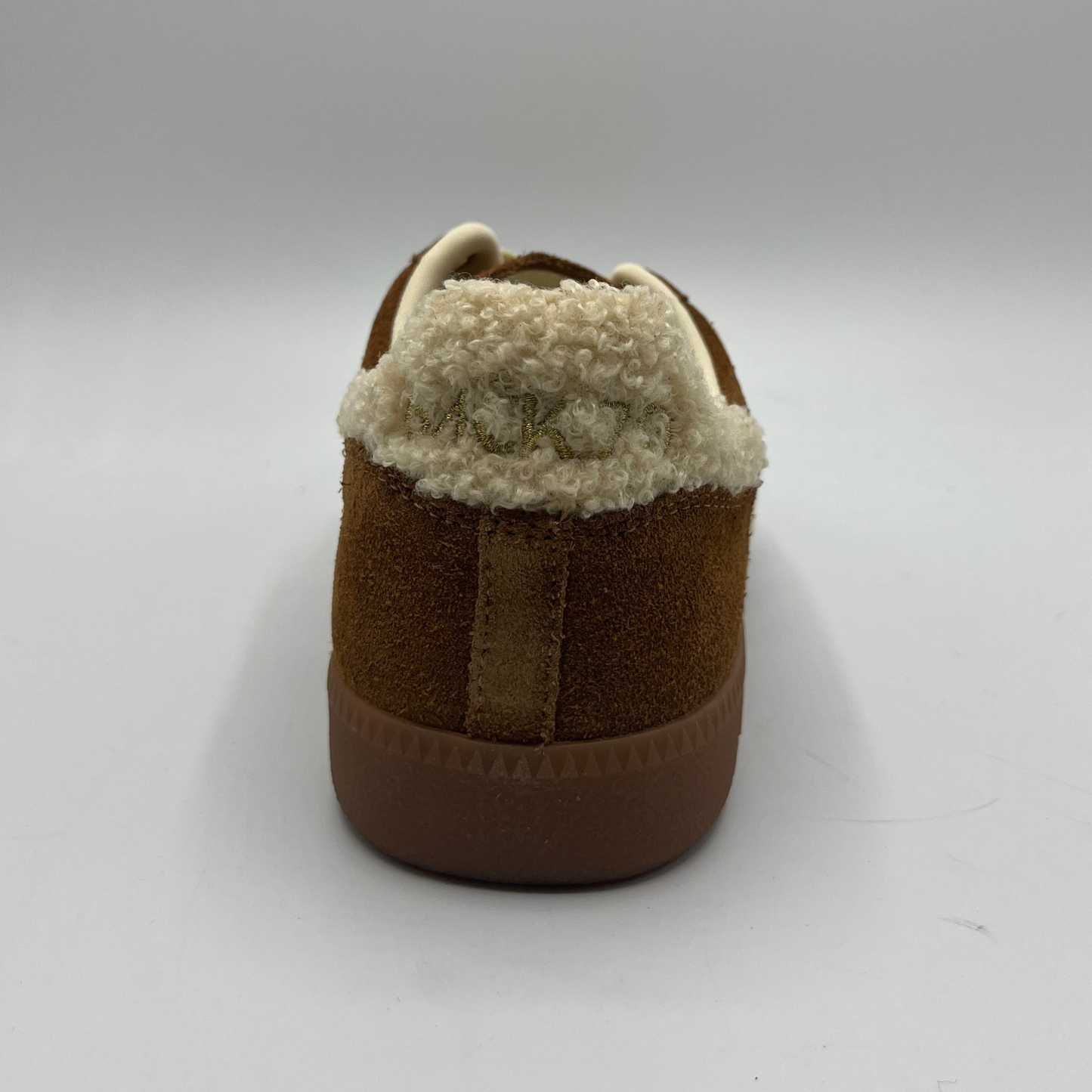 Brown slipper with white fur lining on a white background