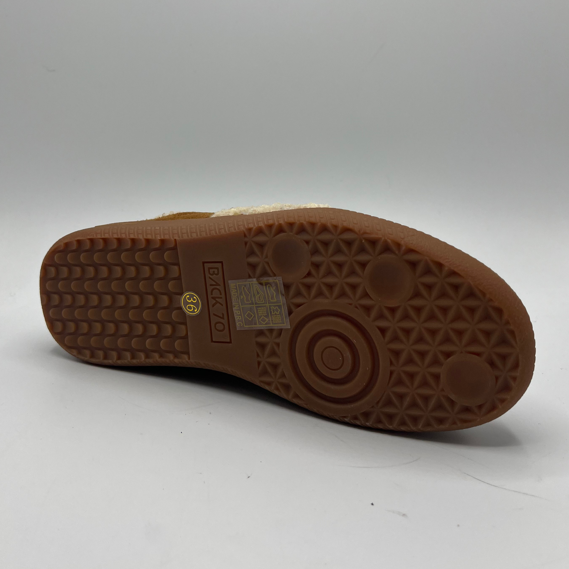 Brown sole of a shoe with a visible brand logo on a white background