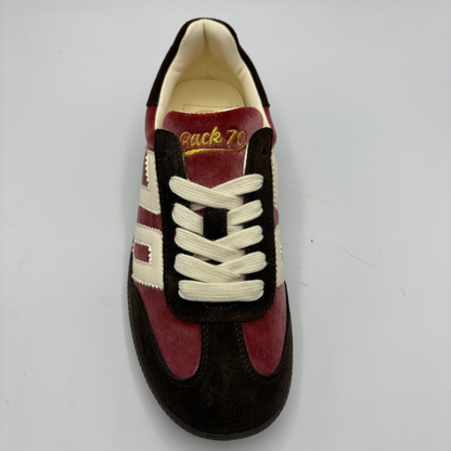A vintage-style low-top sneaker shown from a top-down view on a light gray background. The shoe features dark brown suede panels, burgundy suede overlays, cream-colored laces, and cream side stripes.