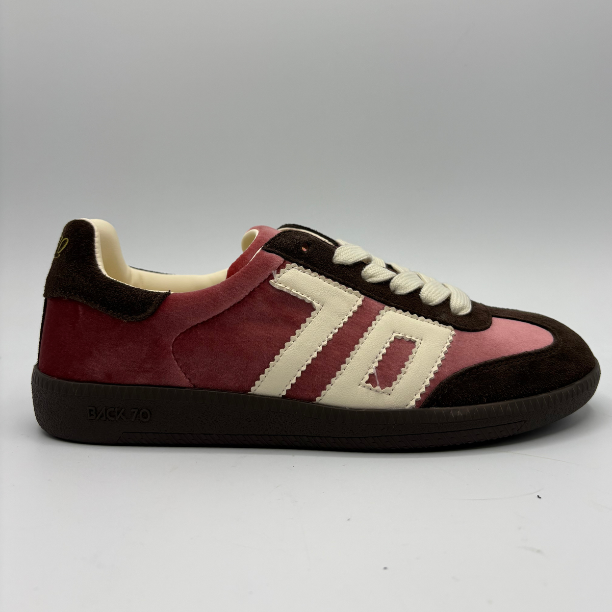 A Back 70 sneaker in pink velvet, and dark brown suede, featuring cream-colored 70 and laces, photographed against a neutral gray background.