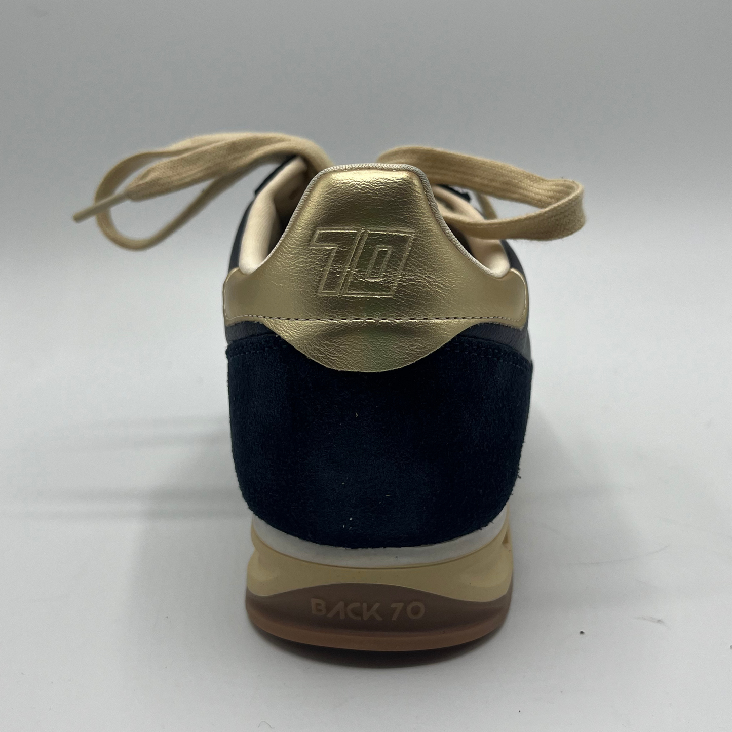 Navy and gold sneaker with '70' logo on a white background