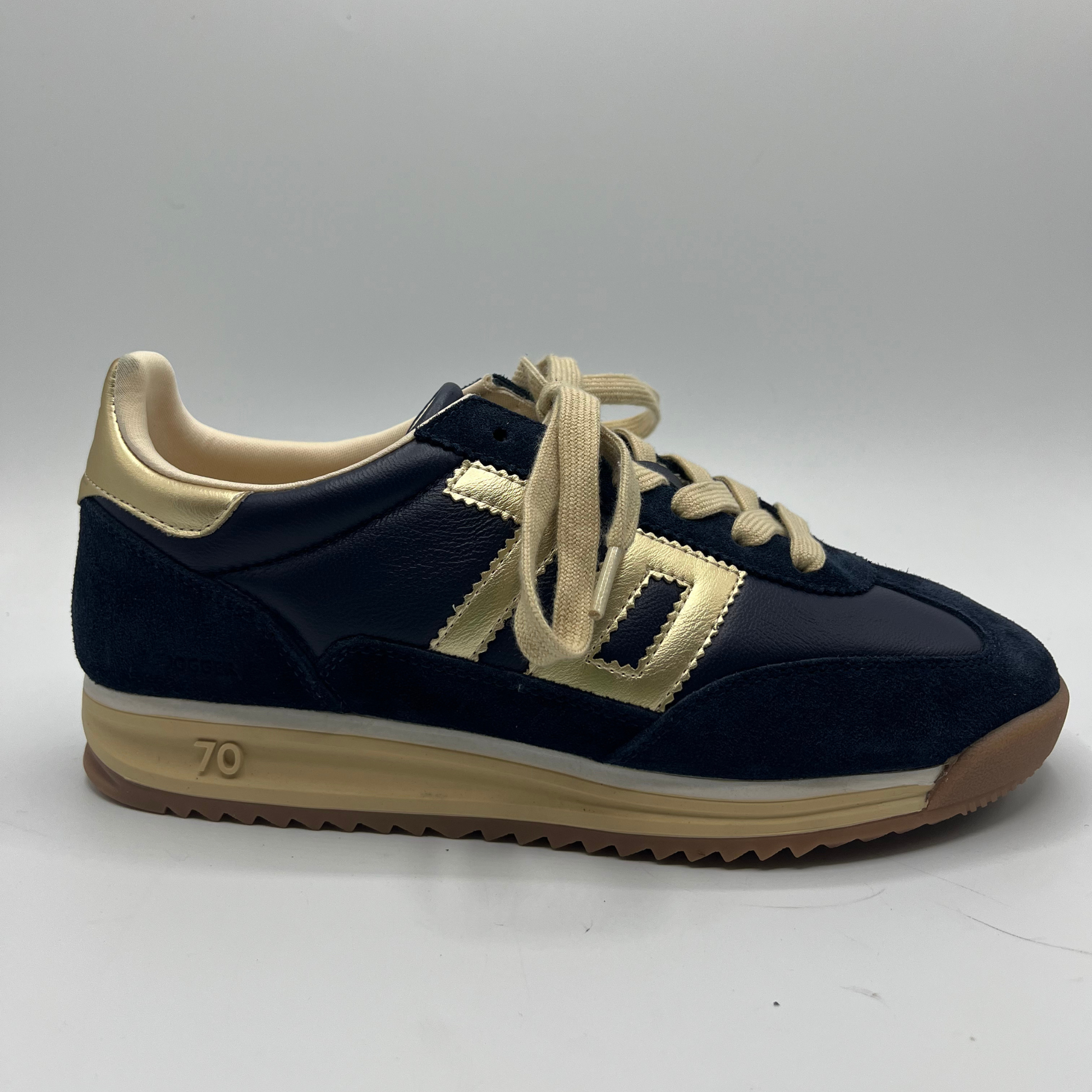 Navy blue and gold sneaker on a white background