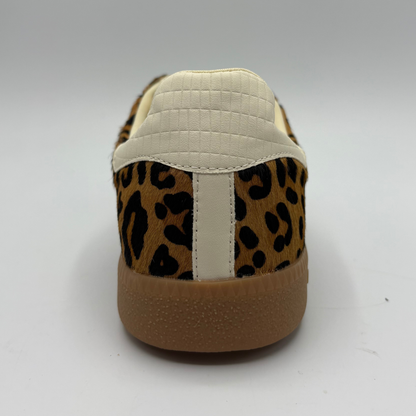 A low-top sneaker featuring a brown and black leopard print pattern on the upper, cream-colored “70”, a cream collar lining, and a brown gum sole with 'BACK 70' embossed on the heel.
