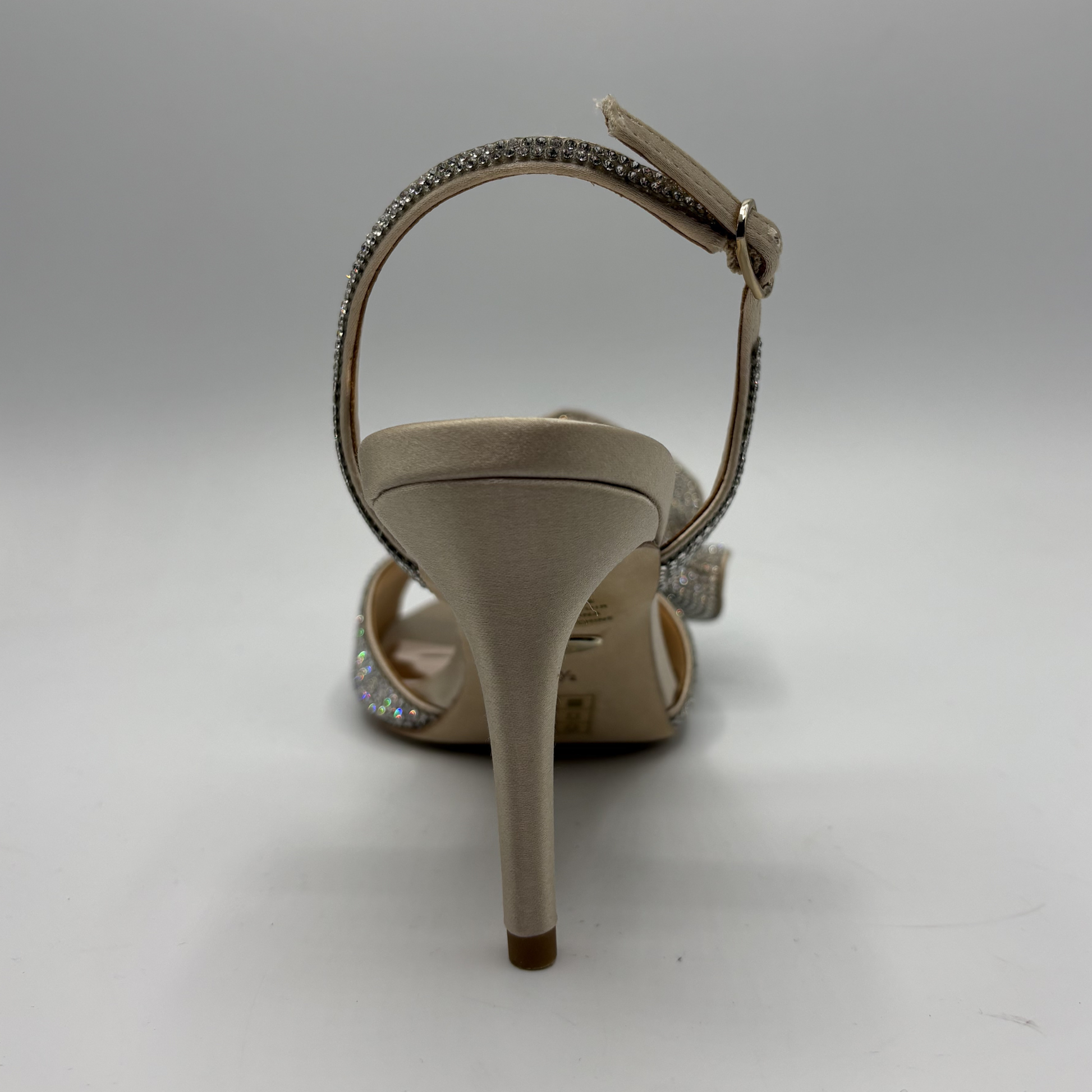 Beige high-heeled sandal with a strap on a gray background