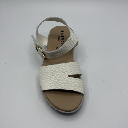 White sandal with brown sole on a white background