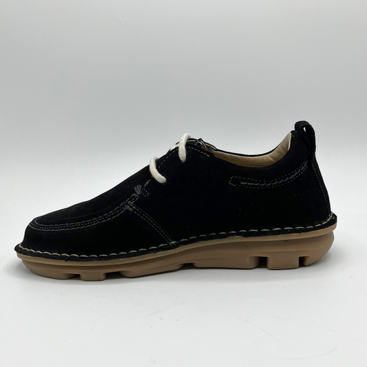 Black shoe with white laces on a light gray background