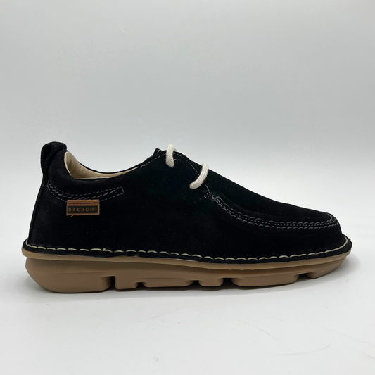 Black shoe with tan sole on a white background