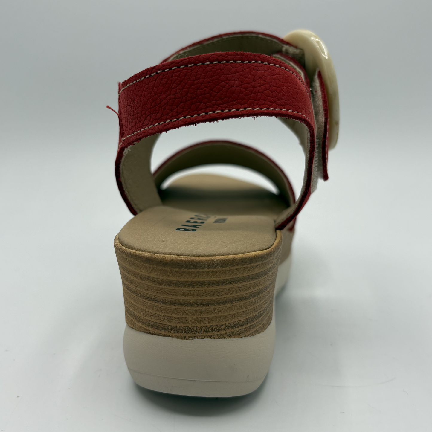 Red sandal with a beige sole on a white background