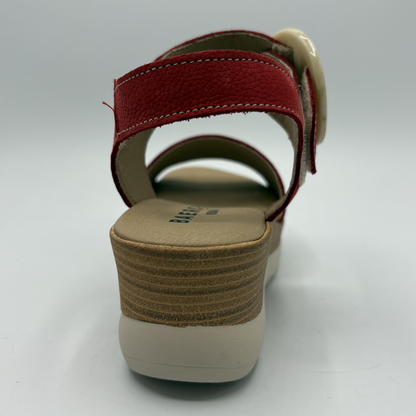 Red sandal with a beige sole on a white background