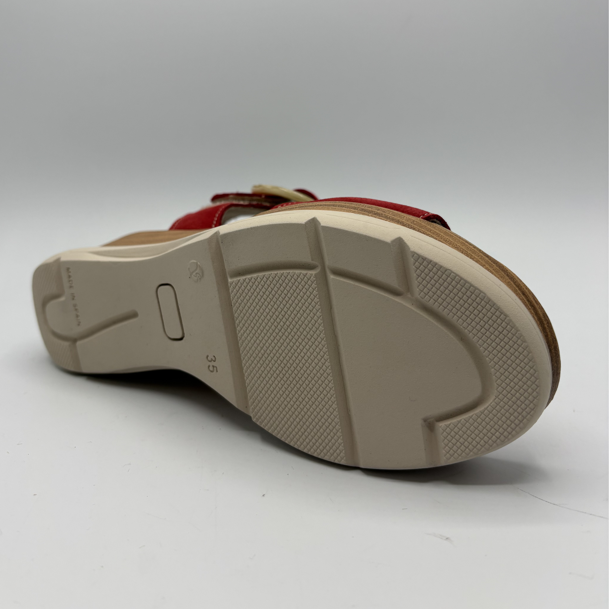 Close-up of a sandal sole with brand logo on a white background