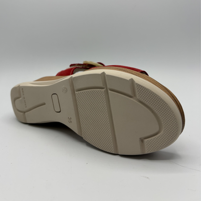 Close-up of a sandal sole with brand logo on a white background