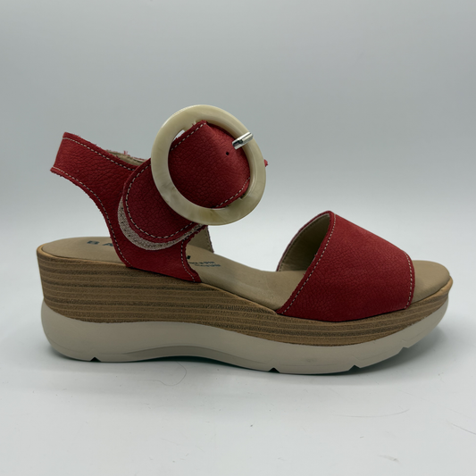 Red sandal with a wooden wedge sole on a white background
