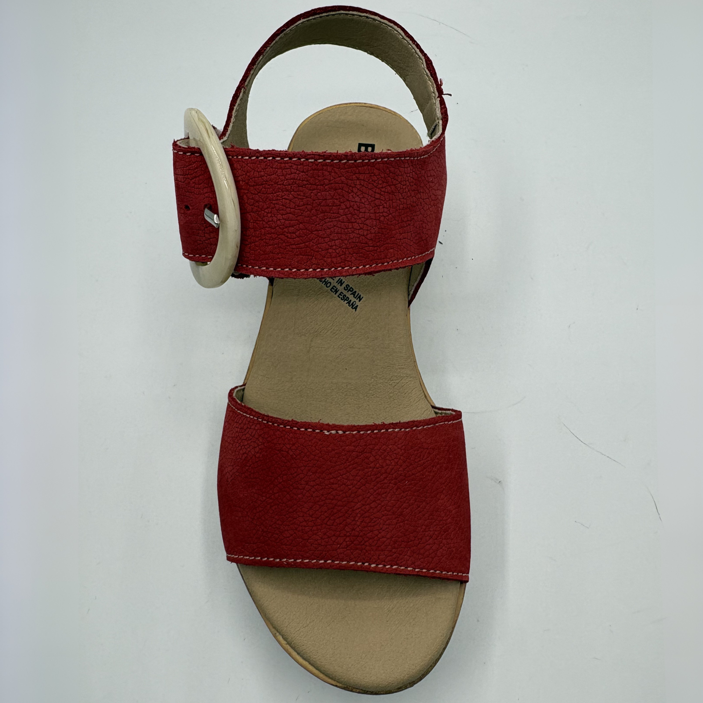 Red sandal with a beige insole on a white background