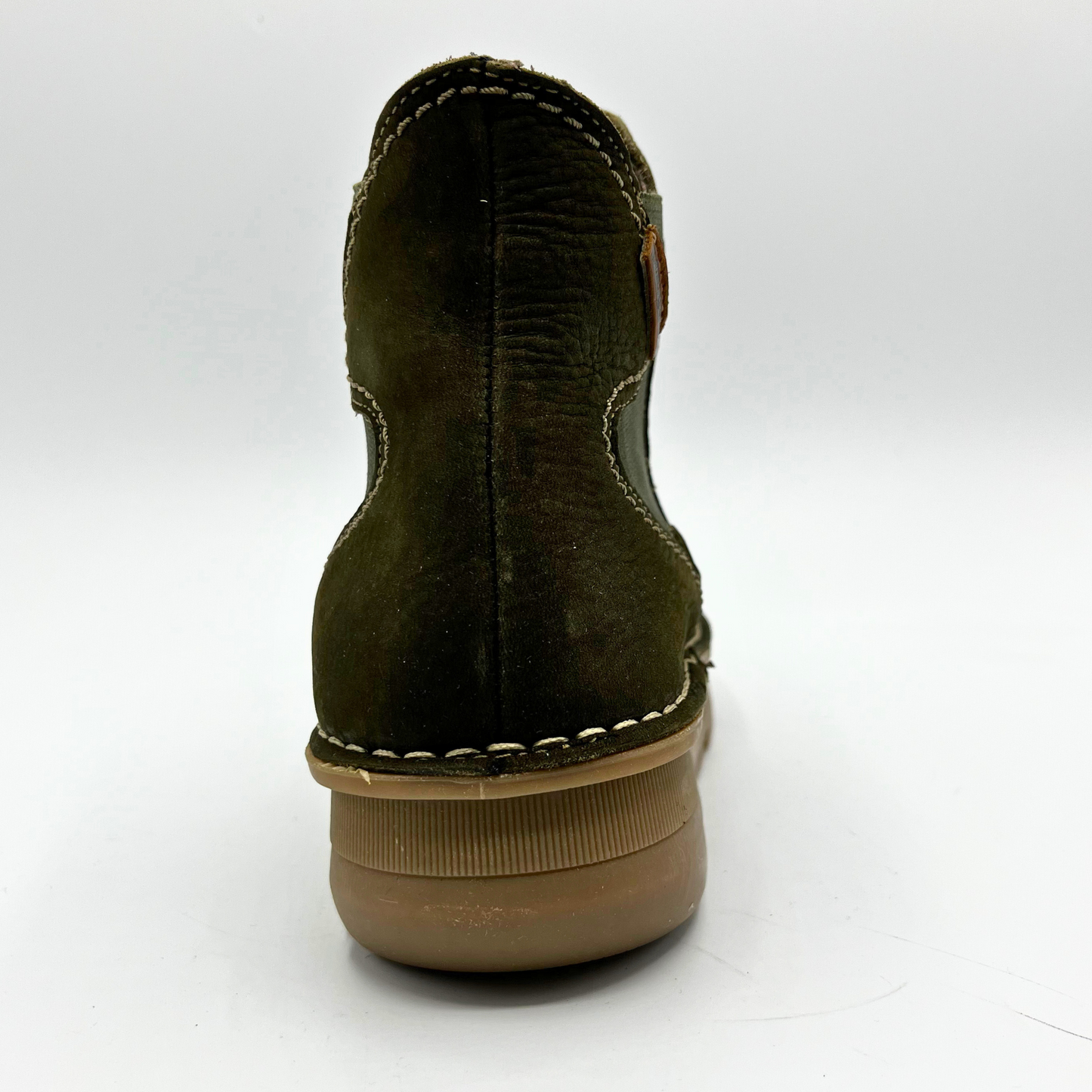 Green suede shoe with brown sole on a white background