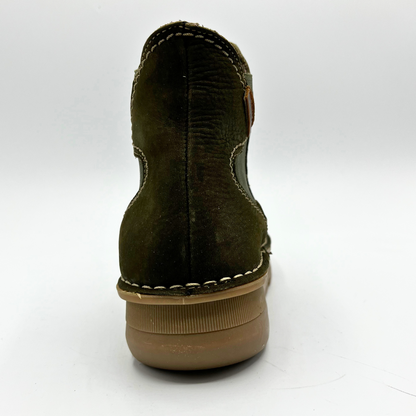 Green suede shoe with brown sole on a white background