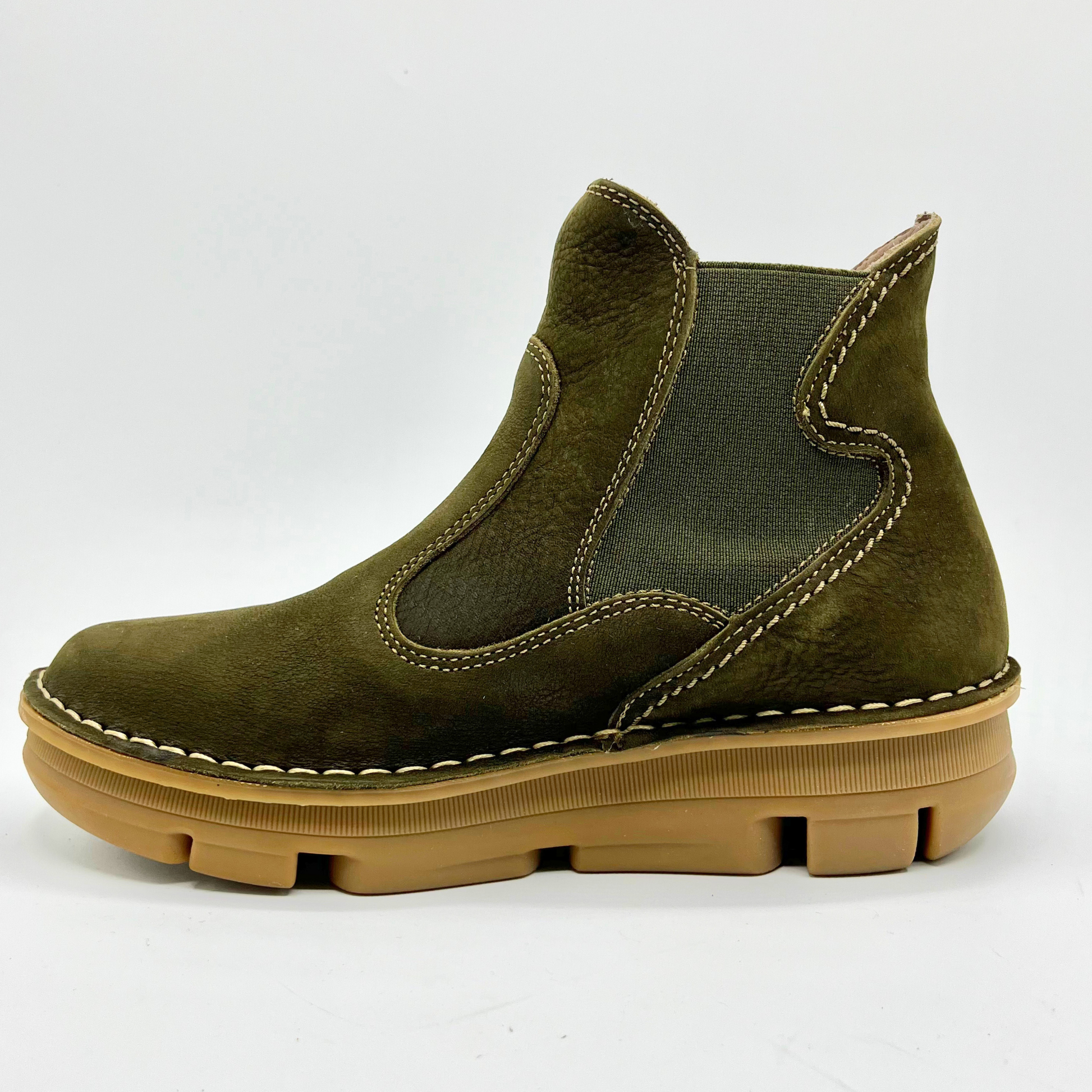 Green suede boot with brown sole on a white background