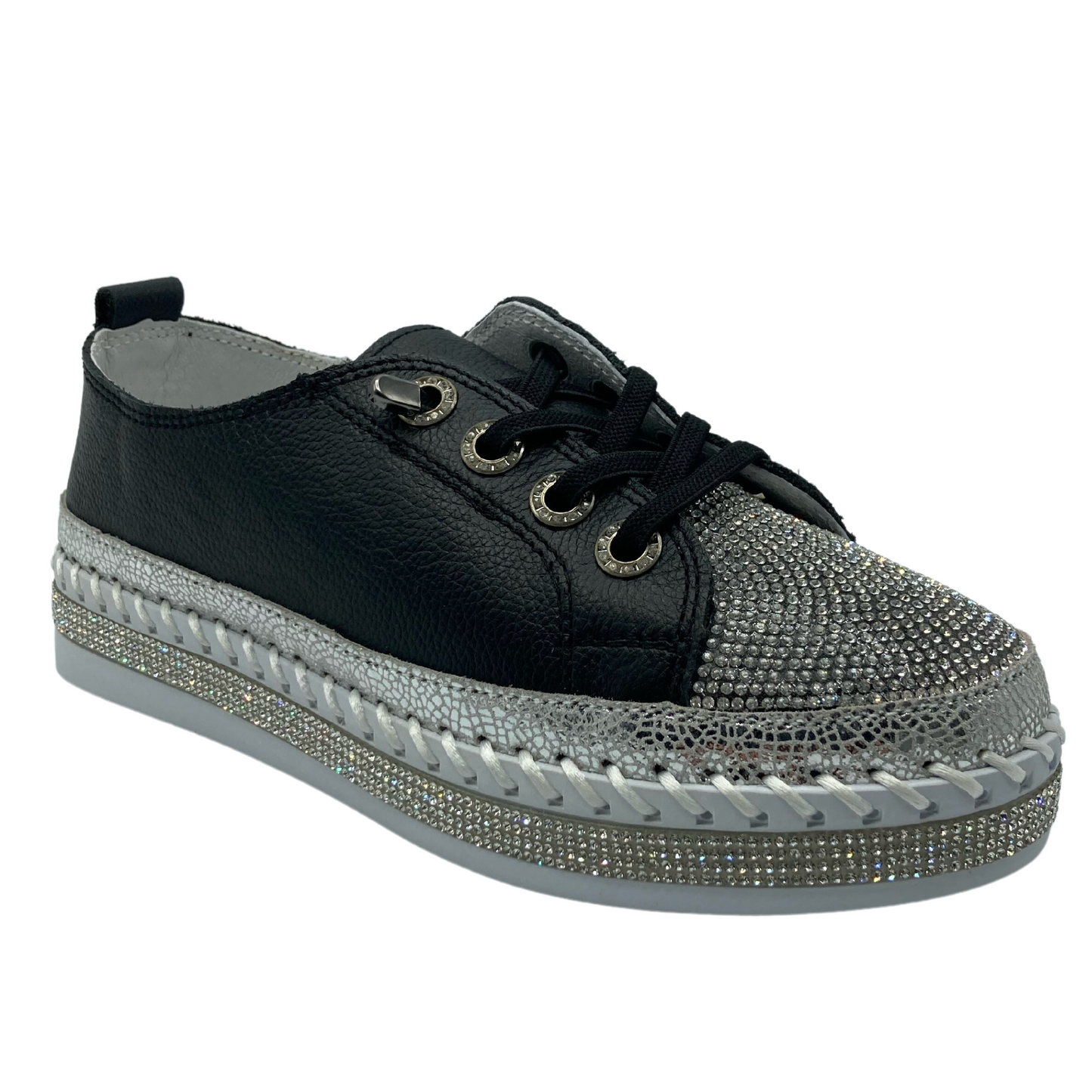 45 degree angled view of bejeweled platform sneaker with leather upper and black laces