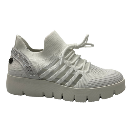 Right facing view of white mesh sneaker with thick rubber sole and crystal details on the heel
