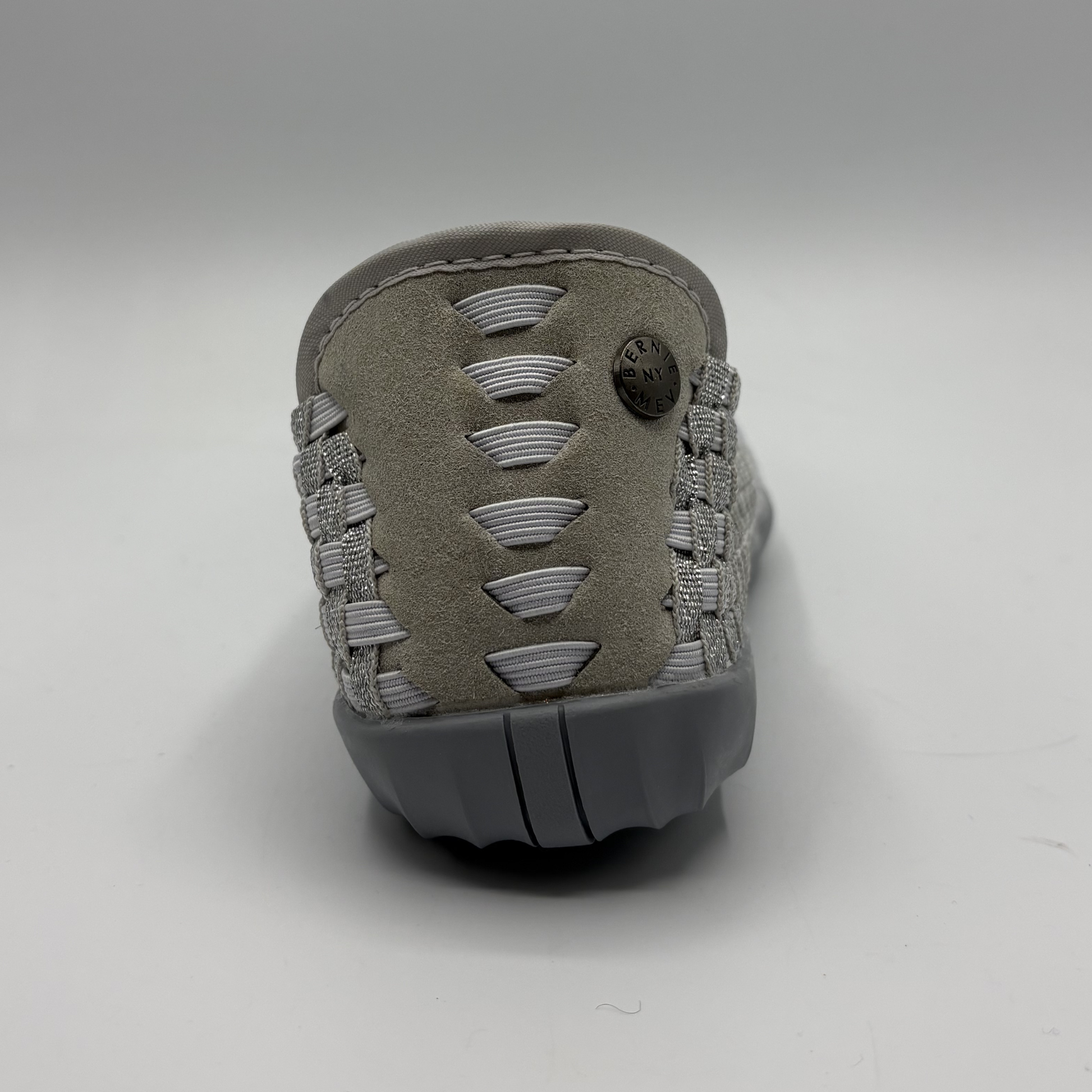 Gray sandal with textured strap design on a white background