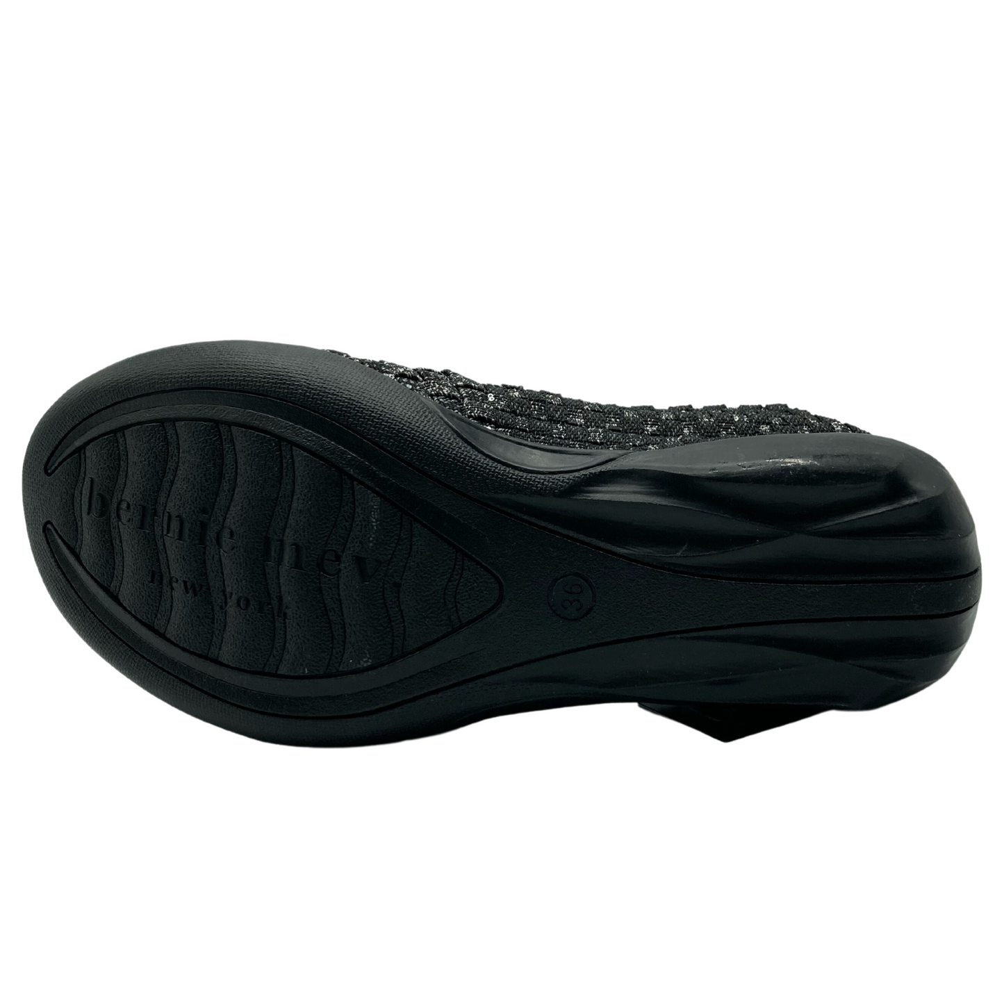 Bottom view of grey flat shoe with black outsole