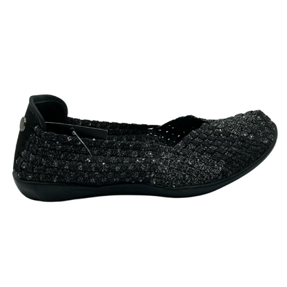 Right facing view of black and grey flat shoe with black outsole