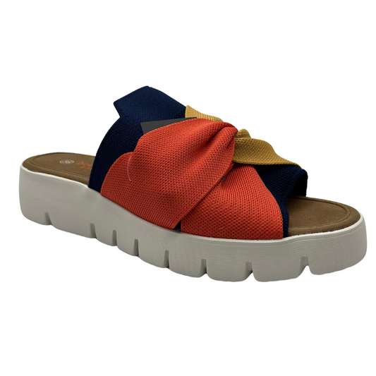 45 degree angled view of mustard, navy and nectarine elastic strap sandal with white rubber outsole