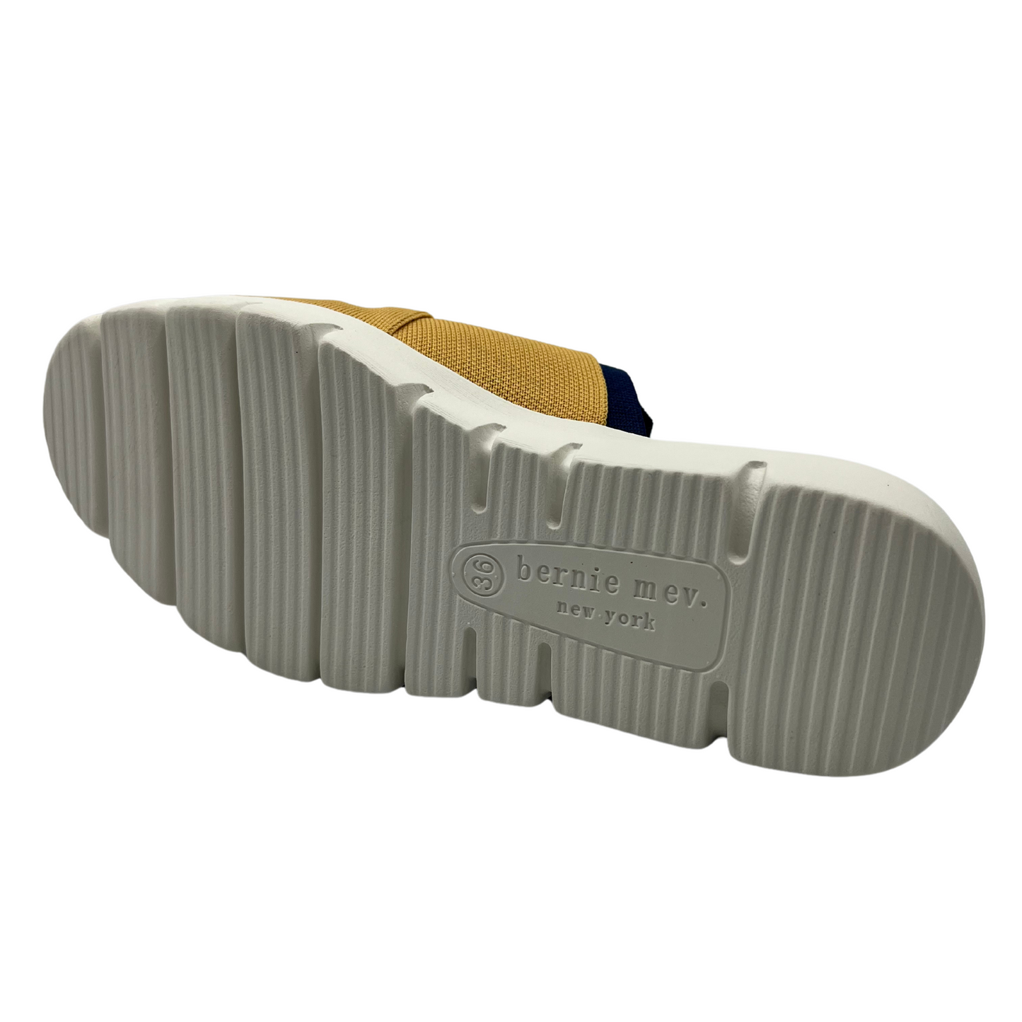 Bottom view of mustard, navy and nectarine elastic strap sandal with white rubber outsole