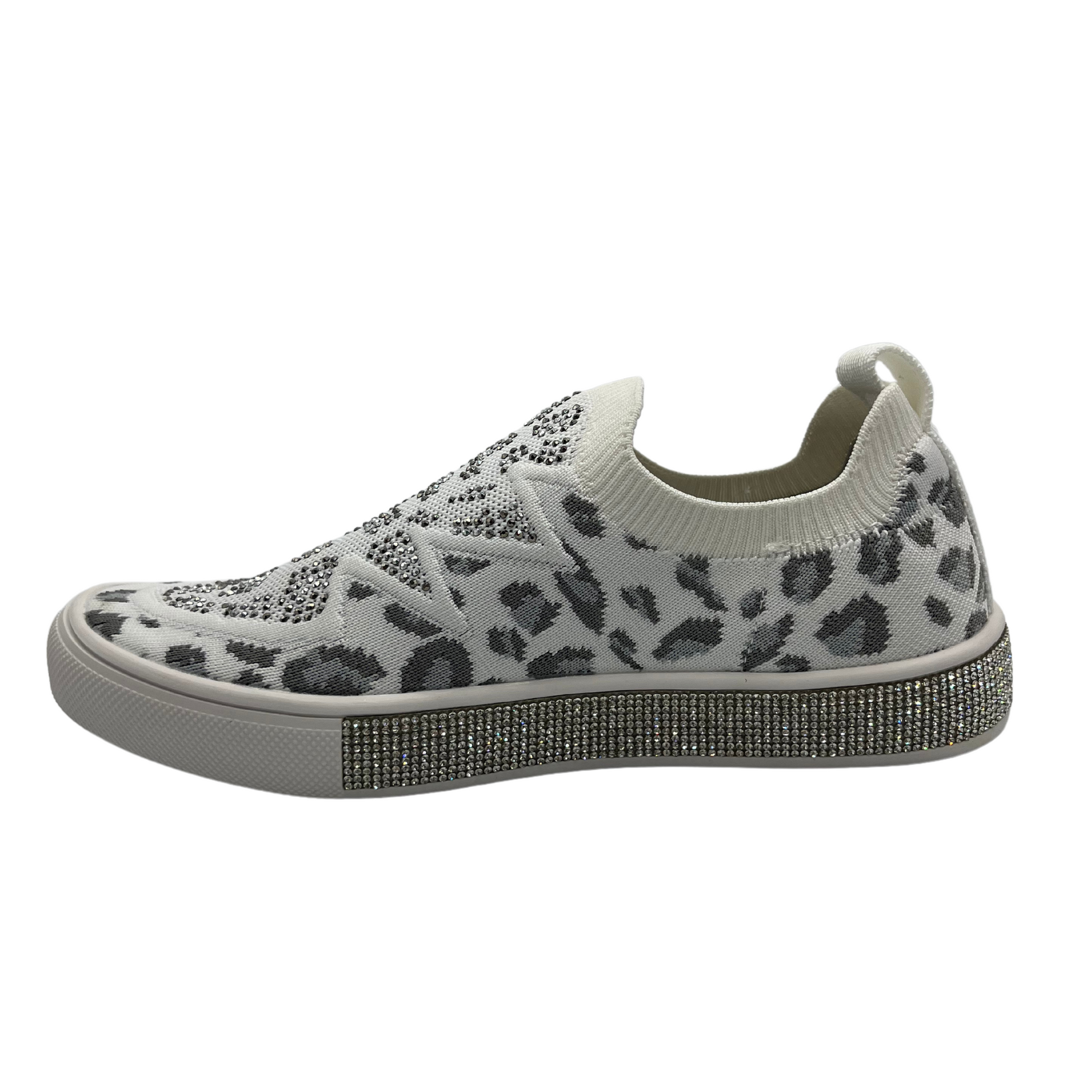 Left facing view of a slip on style sneaker in a fun leopard print with silver crystal accents. Shown in white