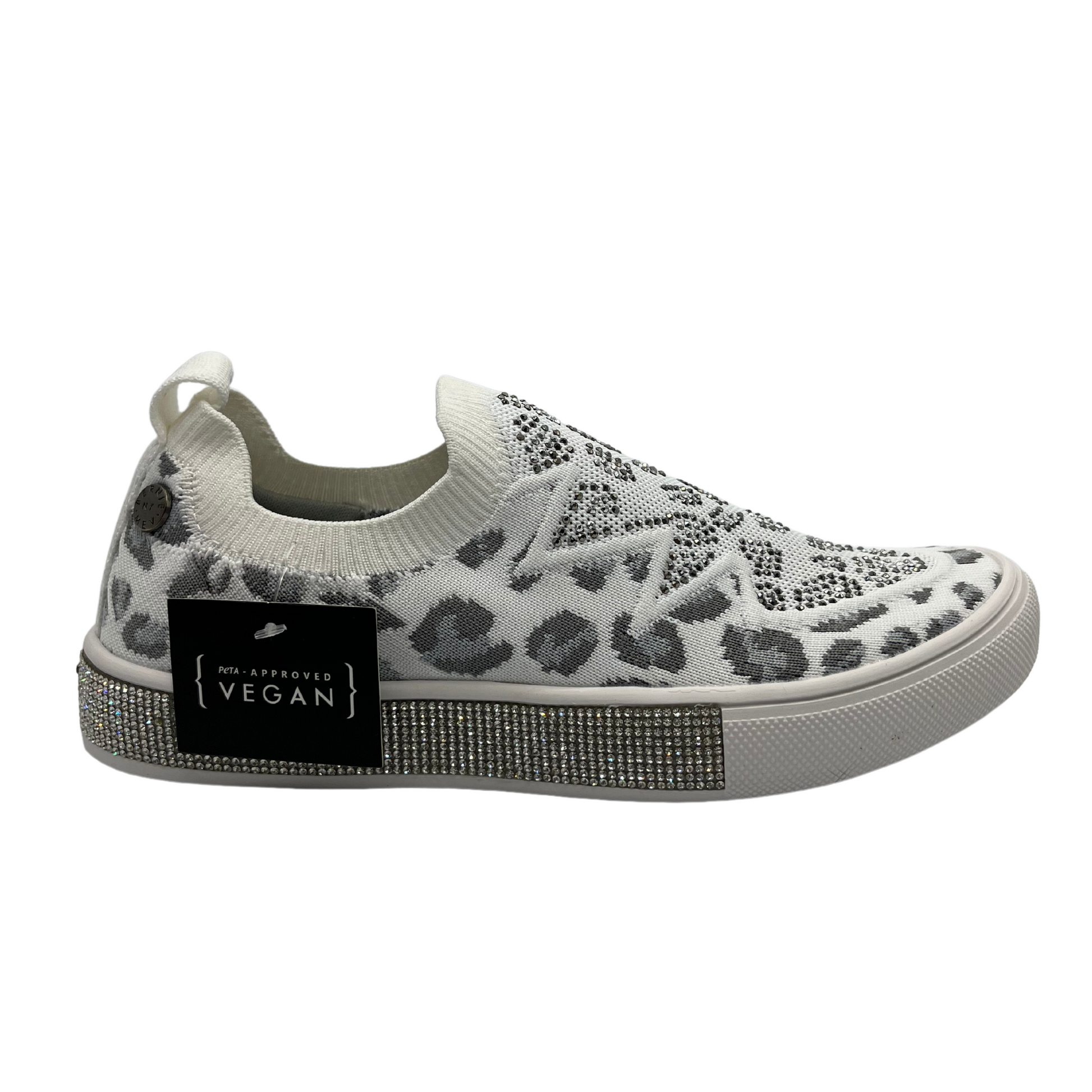 Right facing view of a slip on style sneaker in a fun leopard print with silver crystal accents. Shown in white