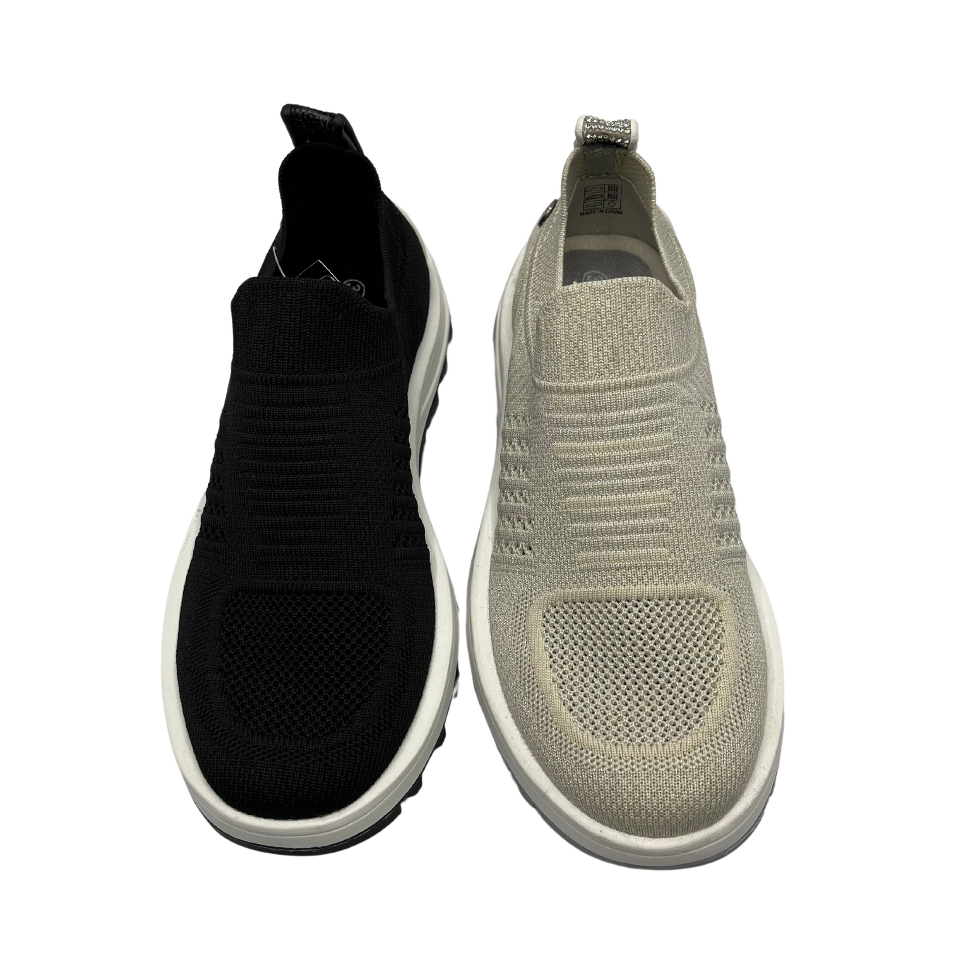 Top view of two knit upper sneakers beside each other. One is black and one is nude shimmer. Both have a pull on heel tab.