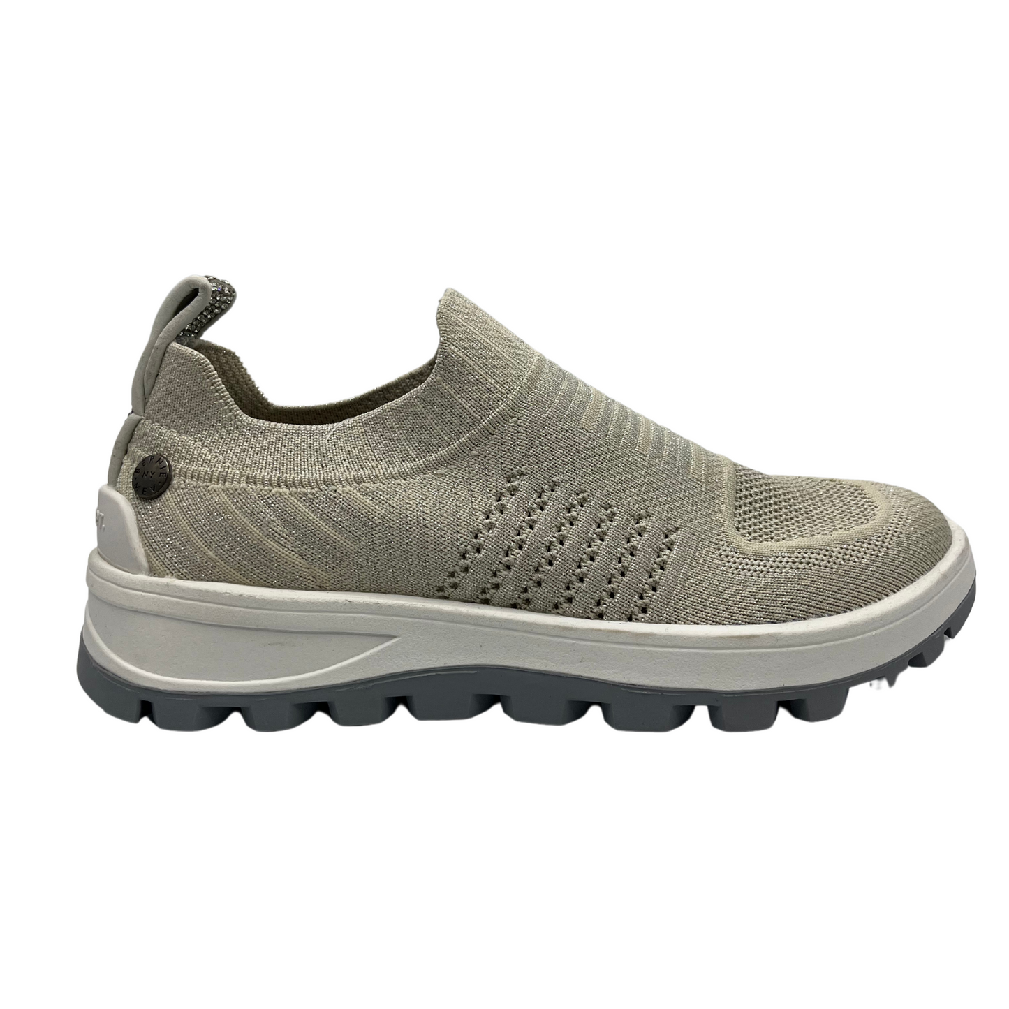 Right facing view of knit upper sneaker with pull on heel tab and lightweight rubber outsole