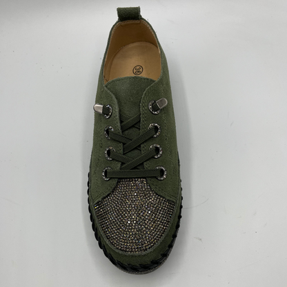 Green sneaker with rhinestone details on a white background