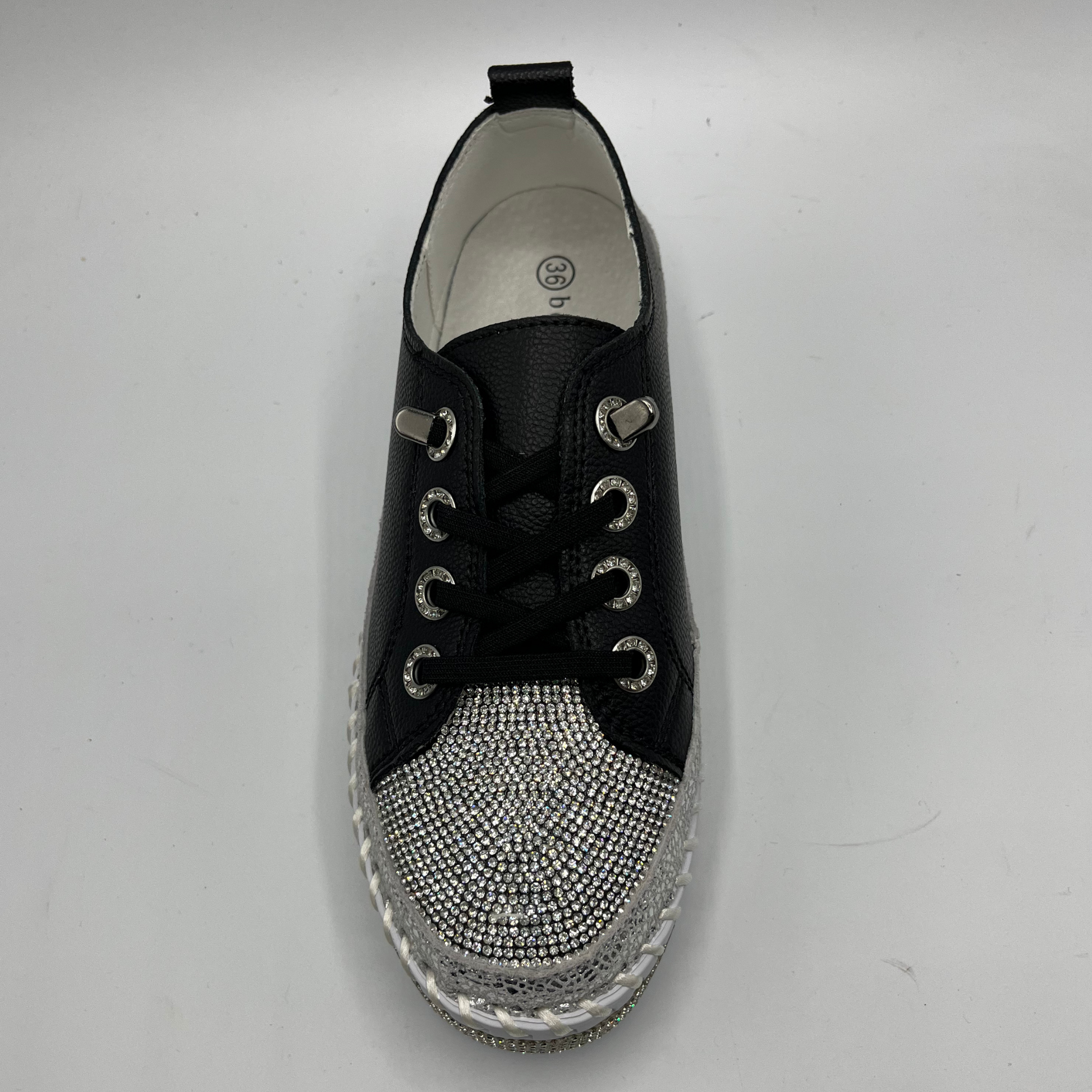 Black sneaker with rhinestone embellishments on a white background