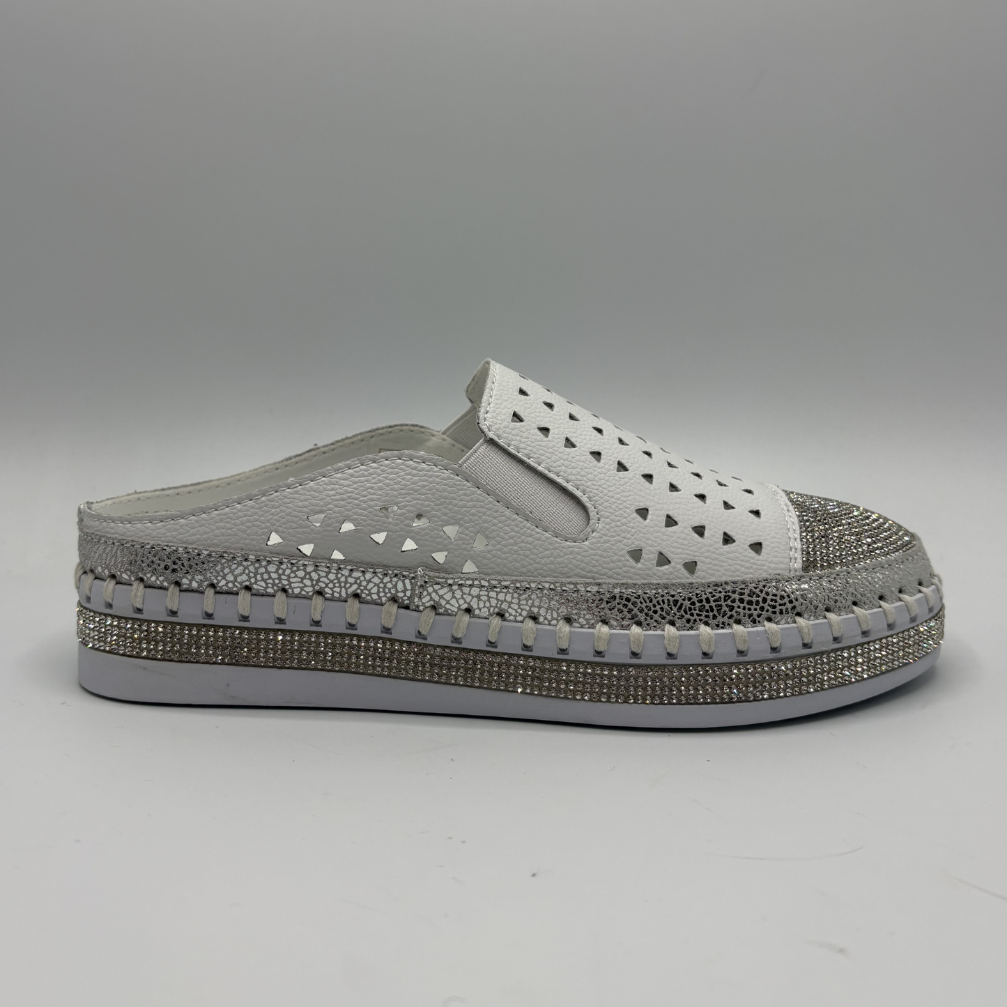 Gray slip-on shoe with decorative sole on a gray background