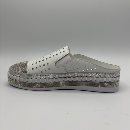 Gray clog shoe with a textured sole on a gray background