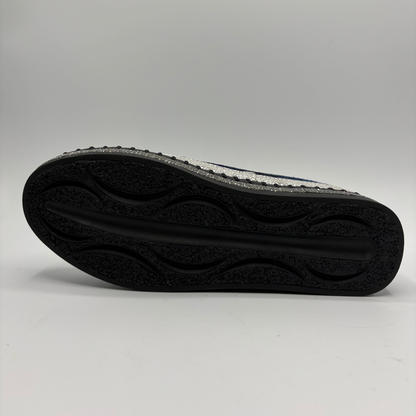 Bottom view of a navy sneaker with rhinestone embellishments and a platform outsole.