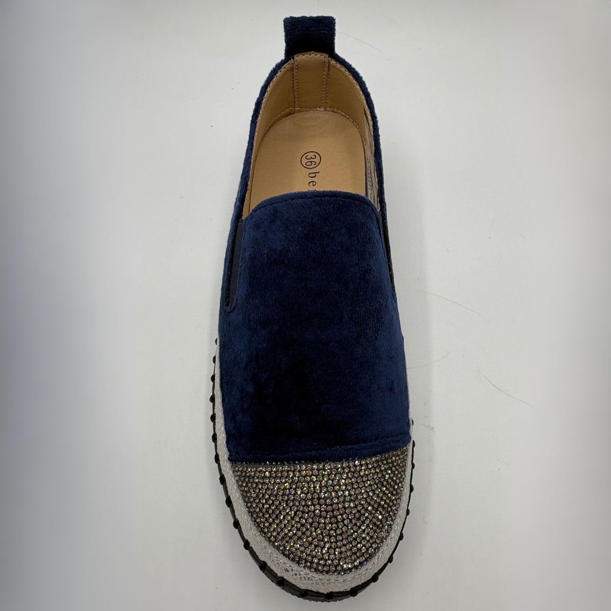 Top view of a navy sneaker with rhinestone embellishments and a platform outsole.