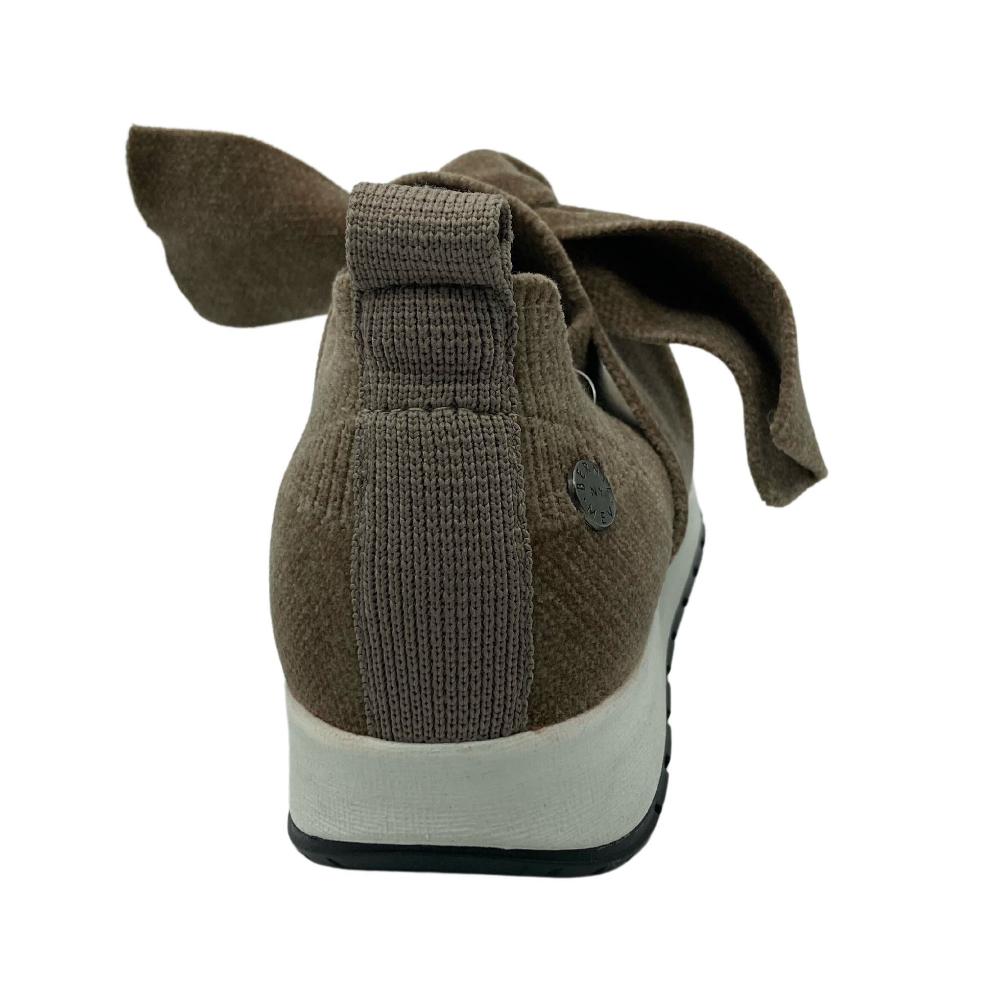 Back view of brown sneaker with large bow detail on upper and white rubber outsole