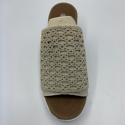 Crocheted sandal strap on a sandal with a white background