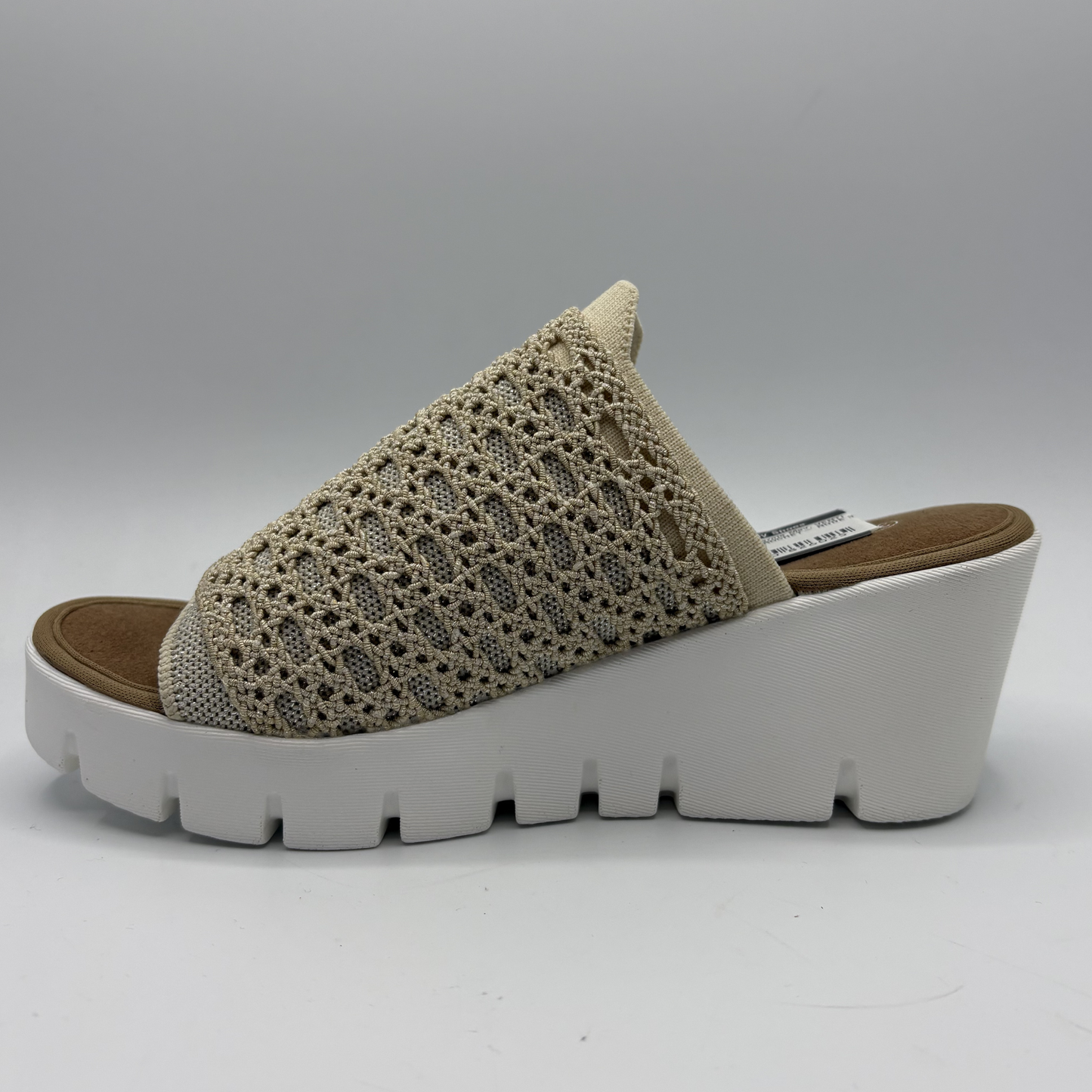 Beige sandal with white sole on a gray background