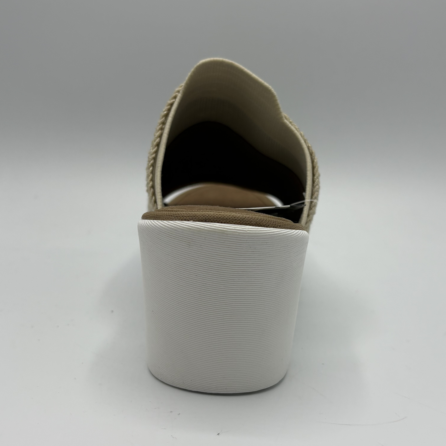White slip-on shoe with beige sole on a white background