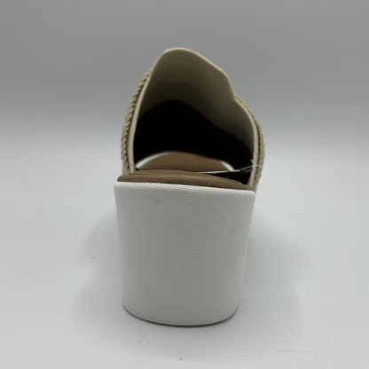 White slip-on shoe with beige sole on a white background