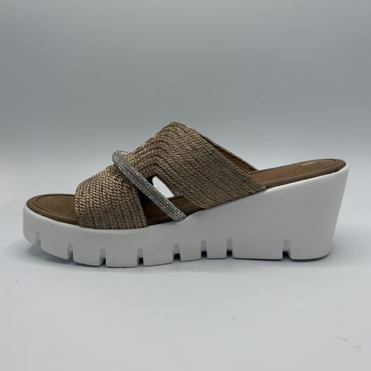 Brown woven sandal with a white sole on a gray background