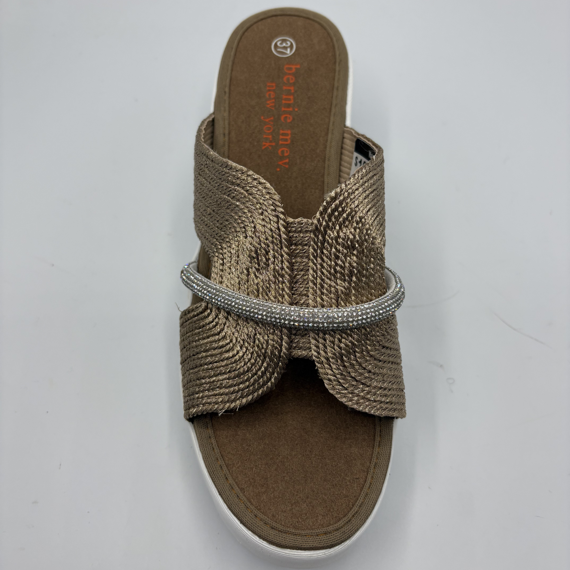 Brown sandal with a decorative band on a white background