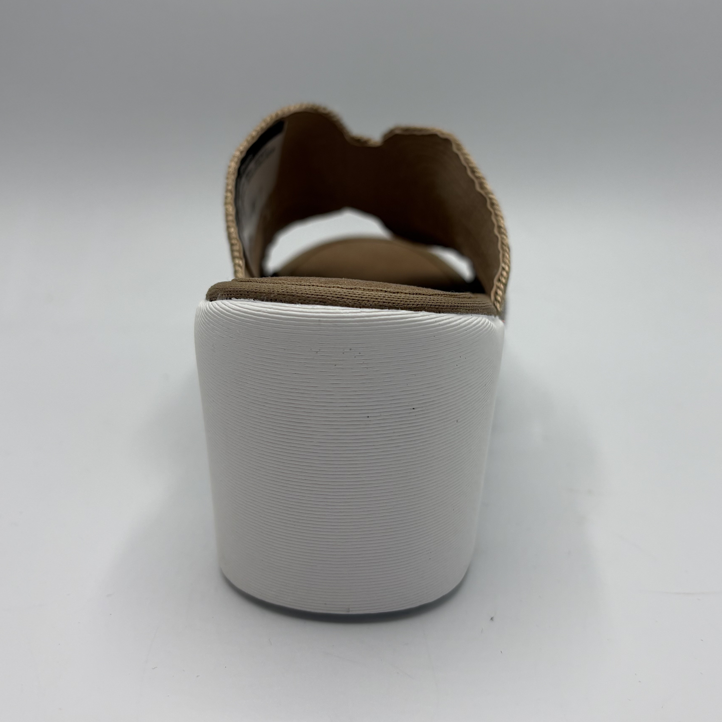 White slipper with brown interior on a white background
