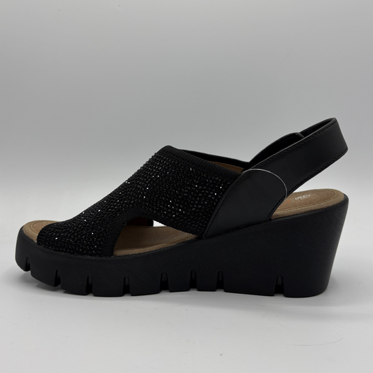 Black wedge sandal with rhinestone embellishments on a gray background