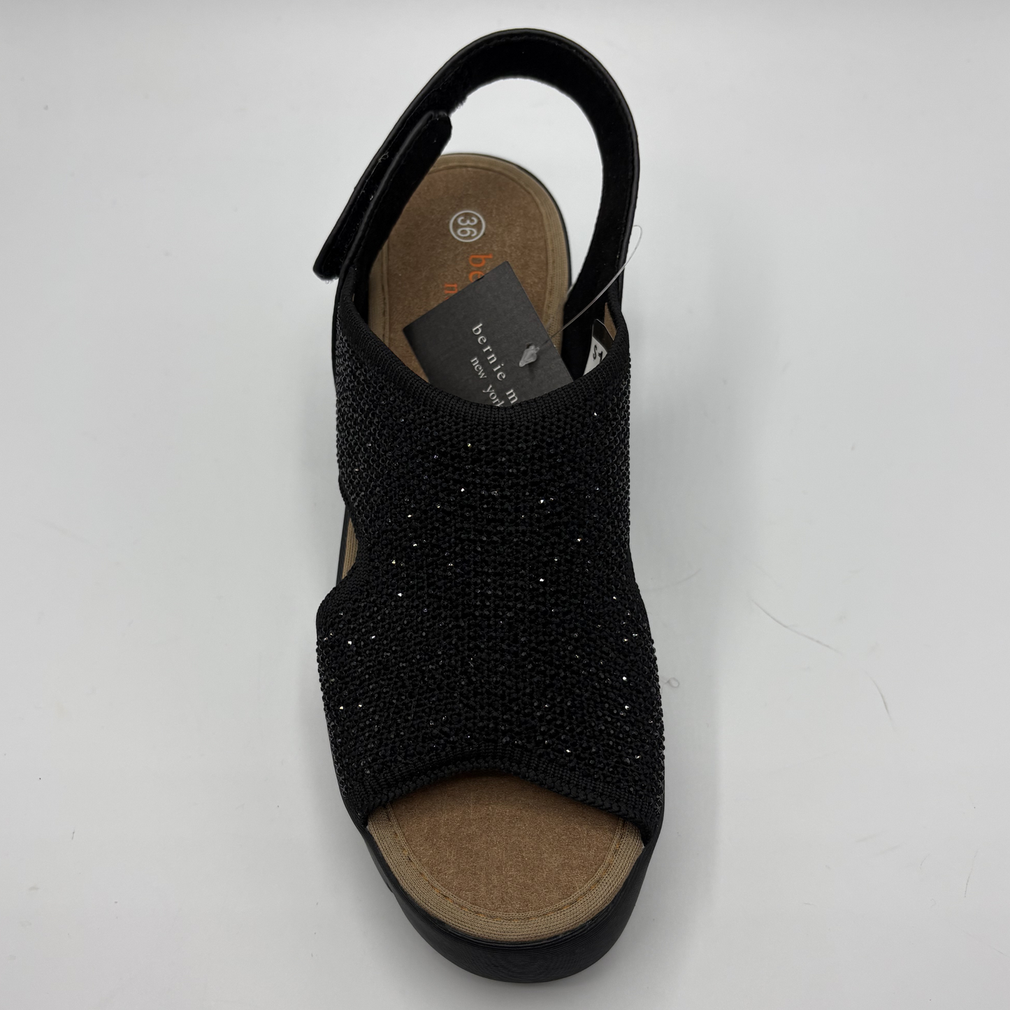 Black sandal with rhinestone details on a white background