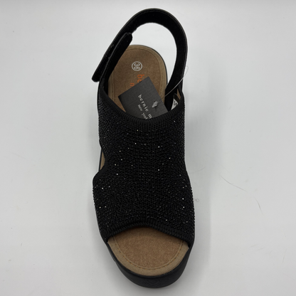Black sandal with rhinestone details on a white background